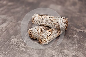 Smoldering ceremonial white sage. Collection of herb bundles.