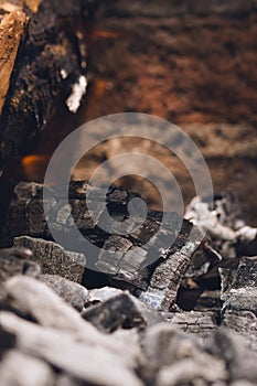 Smoldering embers and ashes in a bonfire. Close up