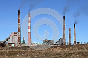 Smoldering pipe working plant pollute the atmosphere of the earth. photo