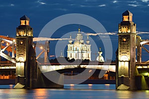 Smolny Cathedral in the alignment of Peter the Great Bridge on a June cloudy night. Saint-Petersburg, Russia