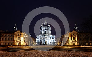 Smolny Cathedral in baroque style under lantern light. Rastrelli Square, Saint Petersburg, Russia. Cityscape in deep winter night