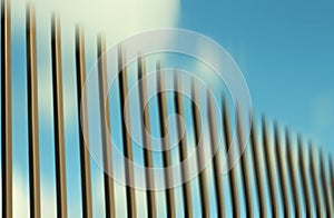 Smooth abstract illustration background. Fence vertical line gradation and the blue sky clouds in the backgrounds. Digital design