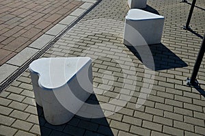 Smooth concrete chair-sized castings. suitable as an urban design barrier to enter the pedestrian zone. shape of mocha sugar cubes