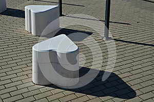 Smooth concrete chair-sized castings. suitable as an urban design barrier to enter the pedestrian zone. shape of mocha sugar cubes