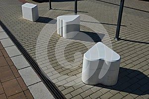 Smooth concrete chair-sized castings. suitable as an urban design barrier to enter the pedestrian zone. shape of mocha sugar cubes