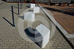 Smooth concrete chair-sized castings. suitable as an urban design barrier to enter the pedestrian zone. shape of mocha sugar cubes