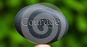 Smooth, dark gray stone engraved with the word \