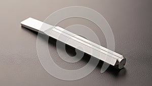 On a smooth dark surface highlighting its metallic texture and precise