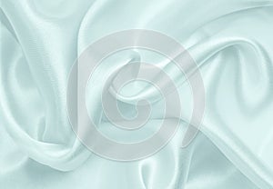 Smooth elegant blue silk or satin luxury cloth texture as abstract background. Luxurious background design