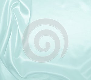 Smooth elegant blue silk or satin luxury cloth texture as abstract background. Luxurious background design