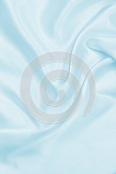 Smooth elegant blue silk or satin luxury cloth texture as abstract background. Luxurious background design