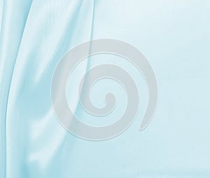 Smooth elegant blue silk or satin luxury cloth texture as abstract background. Luxurious background design