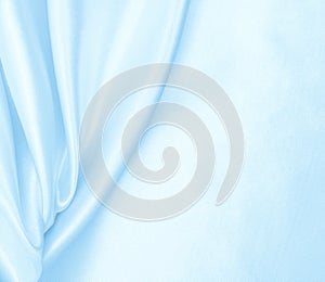 Smooth elegant blue silk or satin luxury cloth texture as abstract background. Luxurious background design