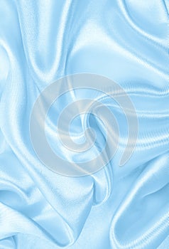 Smooth elegant blue silk or satin luxury cloth texture as abstract background. Luxurious background design