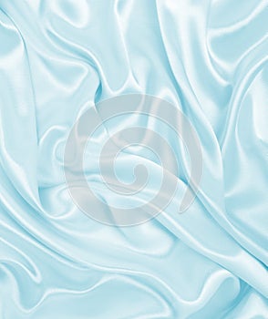 Smooth elegant blue silk or satin luxury cloth texture as abstract background. Luxurious background design