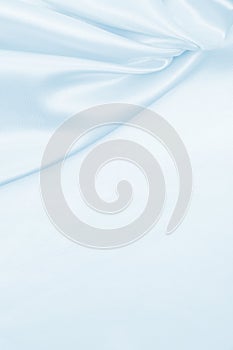 Smooth elegant blue silk or satin luxury cloth texture as abstract background. Luxurious background design