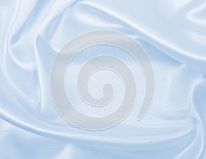 Smooth elegant blue silk or satin luxury cloth texture as abstract background. Luxurious background design