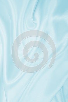 Smooth elegant blue silk or satin luxury cloth texture as abstract background. Luxurious background design