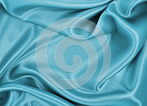 Smooth elegant blue silk or satin luxury cloth texture as abstract background. Luxurious background design