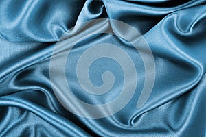 Smooth elegant blue silk or satin luxury cloth texture as abstract background. Luxurious background design