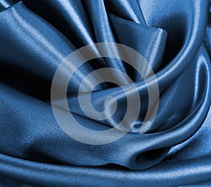 Smooth elegant blue silk or satin luxury cloth texture as abstract background. Luxurious Christmas background or New Year