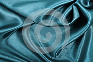 Smooth elegant blue silk or satin luxury cloth texture as abstract background. Luxurious Christmas background or New Year