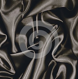 Smooth elegant brown silk or satin texture as abstract background. Luxurious background design. Sepia toned. Retro style