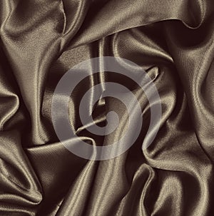 Smooth elegant brown silk or satin texture as abstract background. Luxurious background design. Sepia toned. Retro style