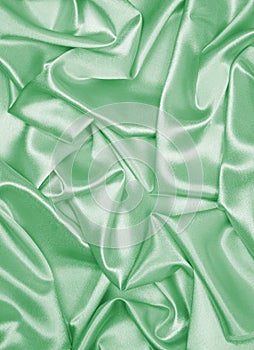 Smooth elegant green silk or satin as background