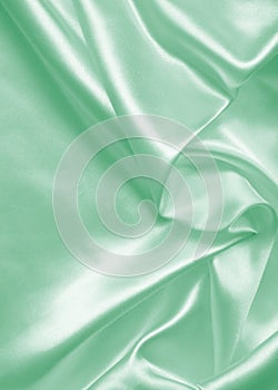 Smooth elegant green silk or satin as background