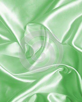 Smooth elegant green silk or satin texture as background