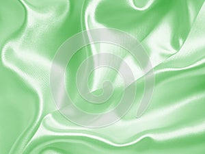 Smooth elegant green silk or satin texture as background