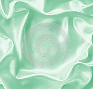 Smooth elegant green silk or satin texture as background