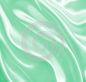 Smooth elegant green silk or satin texture as background