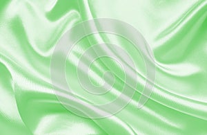 Smooth elegant green silk or satin texture as background