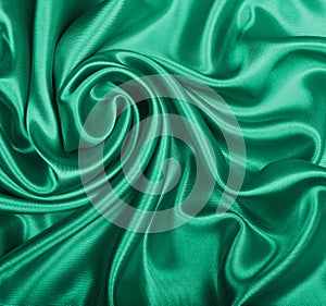 Smooth elegant green silk or satin texture as background