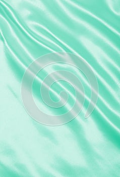 Smooth elegant green silk or satin texture as background