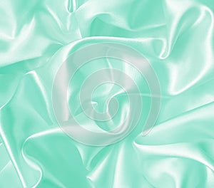 Smooth elegant green silk or satin texture as background