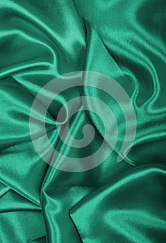 Smooth elegant green silk or satin texture as background