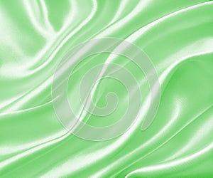 Smooth elegant green silk or satin texture as background