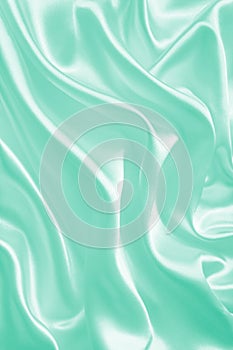 Smooth elegant green silk or satin texture as background