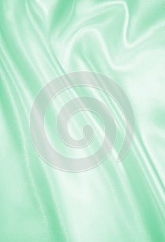 Smooth elegant green silk or satin texture as background