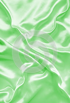 Smooth elegant green silk or satin texture as background