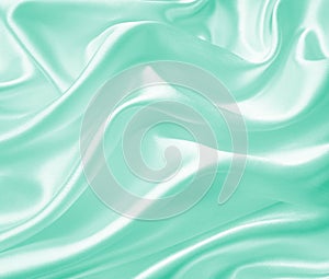 Smooth elegant green silk or satin texture as background