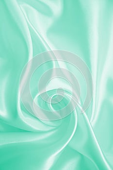 Smooth elegant green silk or satin texture as background