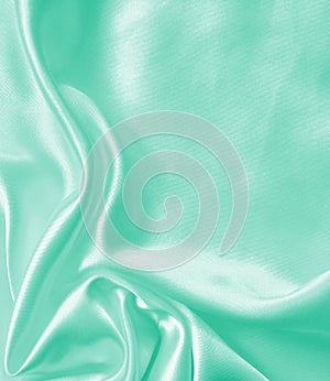 Smooth elegant green silk or satin texture as background