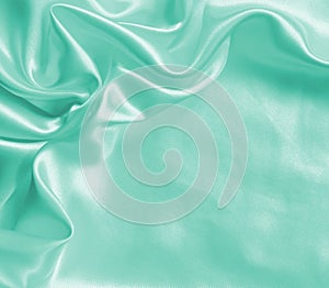 Smooth elegant green silk or satin texture as background