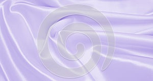 Smooth elegant lilac silk or satin texture as wedding background. Luxurious background design