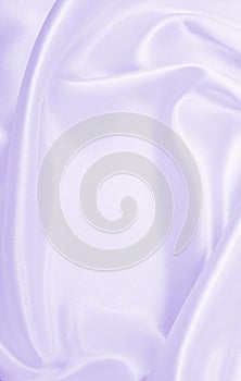 Smooth elegant lilac silk or satin texture as wedding background. Luxurious background design