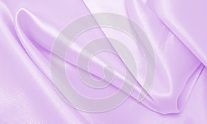 Smooth elegant lilac silk or satin texture as wedding background. Luxurious background design